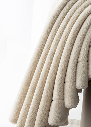 a stack of white towels sitting on top of a white shelf