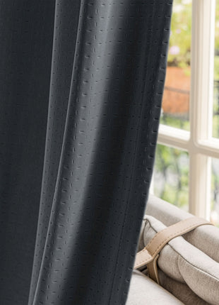 a close up of a curtain with a window in the background