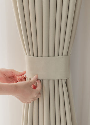 a woman's hand pulling a curtain off of the side of a window