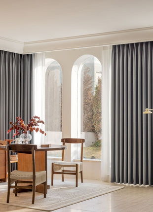 a living room filled with furniture and a large window