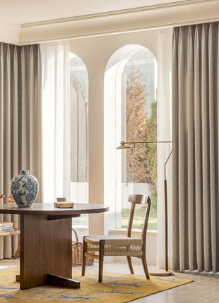 a living room with a table and chairs