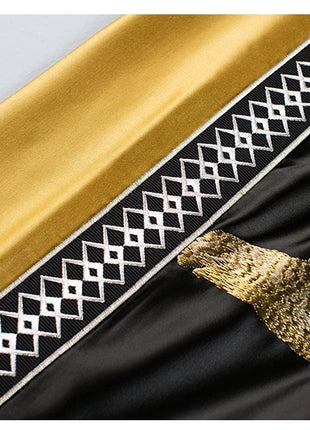 a close up of a black and gold cloth