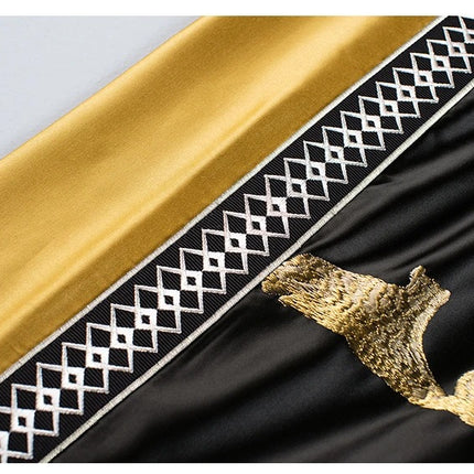 a close up of a black and gold cloth