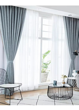 a living room filled with furniture and a large window