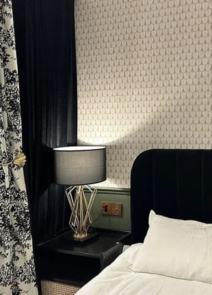 a bedroom with a black headboard and a white bed