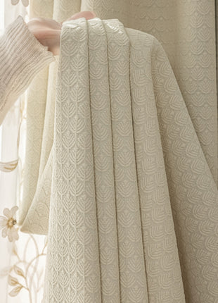 a person holding a curtain in front of a window