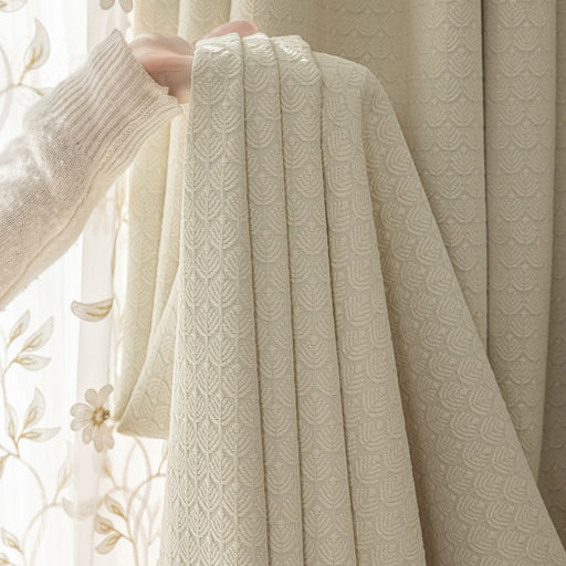 a person holding a curtain in front of a window