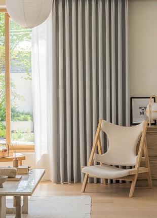 a living room filled with furniture and a large window