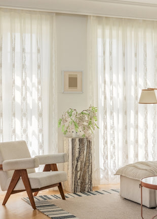a living room filled with furniture and a large window