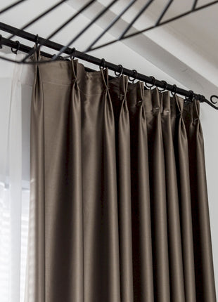 a close up of a curtain with a metal rod