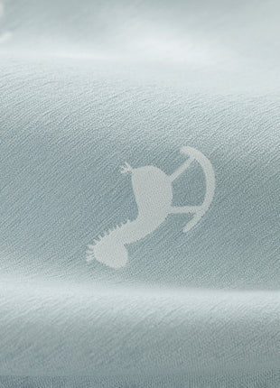 a close up of a shirt with a bird on it