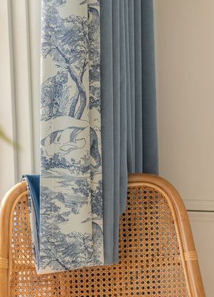 a blue and white curtain hanging from a window