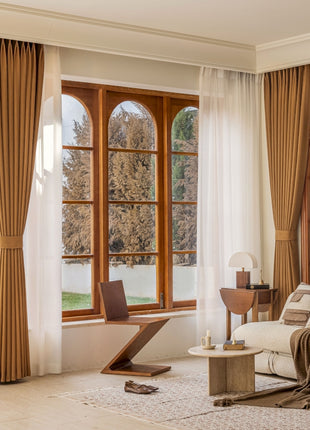 a living room filled with furniture and large windows