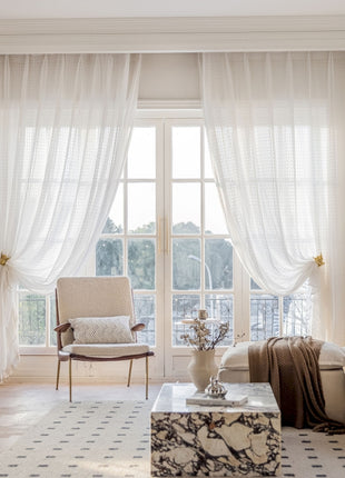a living room filled with furniture and a large window