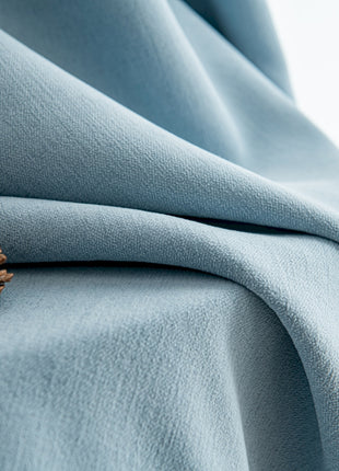 a pine cone is sitting on a blue blanket