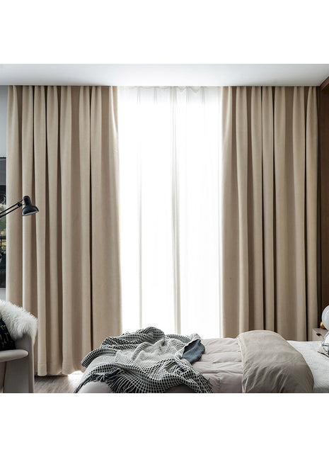 a bed room with a neatly made bed and a large window