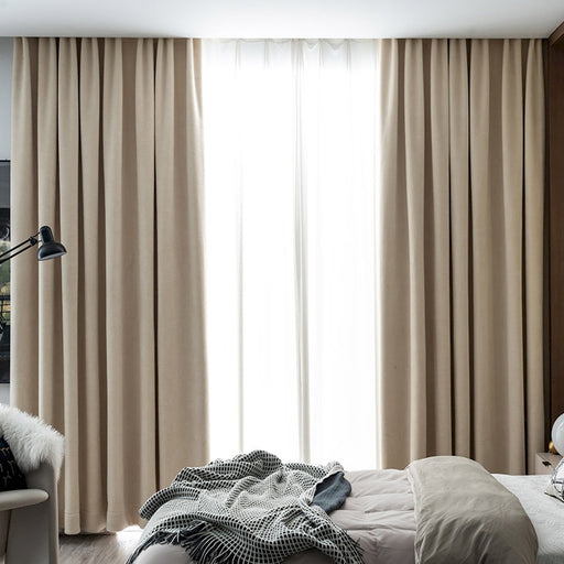 a bed room with a neatly made bed and a large window