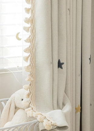 a teddy bear sitting in a crib next to a window