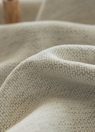 a close up of a cloth with a wooden object in the background