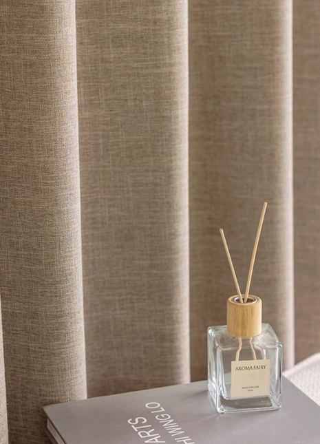 a bottle of perfume sitting on top of a book