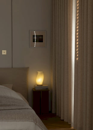 a bedroom with a bed and a night stand