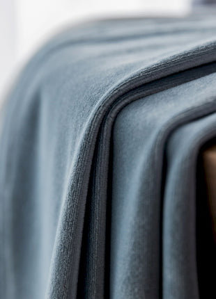 a close up of a bed with a blanket on top of it