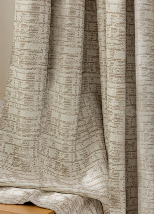 a white vase with a flower in it next to a curtain