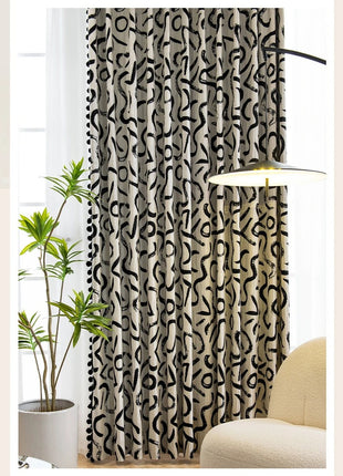 a living room with a chair and a curtain