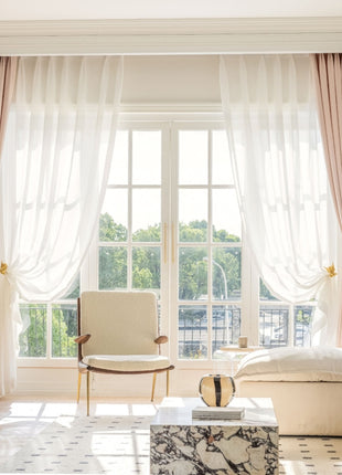 a living room filled with furniture and a large window