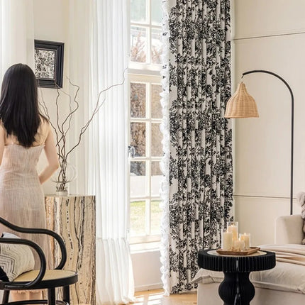 a woman standing in a living room next to a window