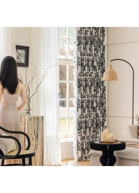 a woman standing in a living room next to a window