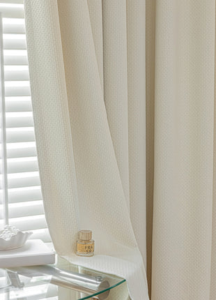 a bedroom with a glass table and white curtains