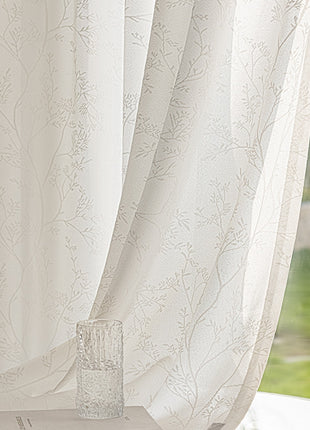 a vase sitting on a table next to a window