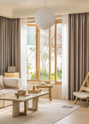 a living room filled with furniture and a large window