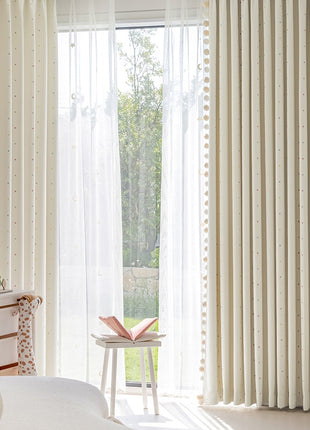 a bedroom with a white bed and white curtains
