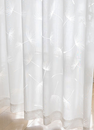 a cat sitting on the floor in front of a curtain