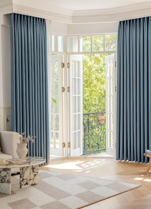 a living room filled with furniture and a large window