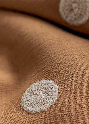 a close up of a blanket with a white circle on it