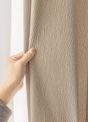 a person is opening the curtains with their hand