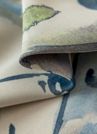 a close up of a blue and green flowered fabric