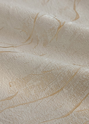 a close up of a white fabric with gold lines