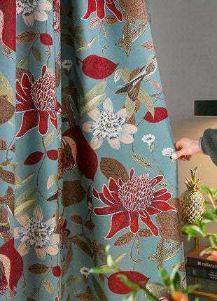 a person is opening a curtain with a flower pattern