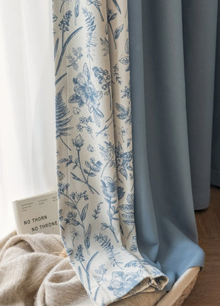a close up of a curtain with blue flowers on it