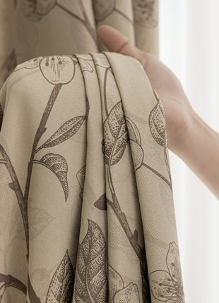 a person holding a curtain with a flower pattern