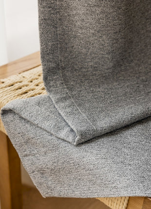 a close up of a chair with a blanket on it