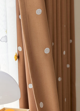 a white lamp sitting on top of a table next to a window