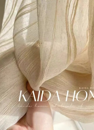 a woman's hand is holding a curtain