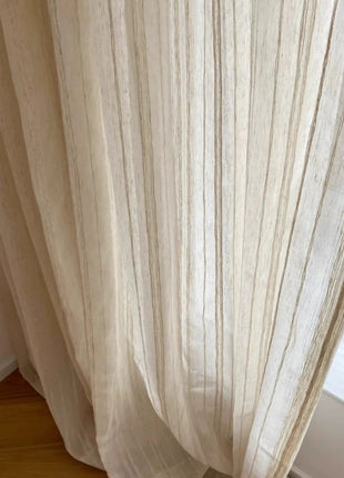 a white curtain hanging on a window sill