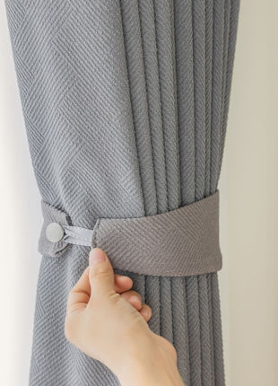 a person is pulling the curtain off of a window