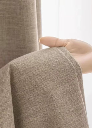 a person holding a curtain with their hand